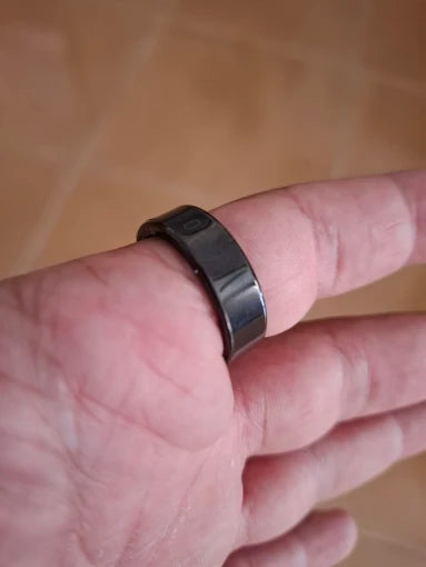 Black smart ring on finger side view